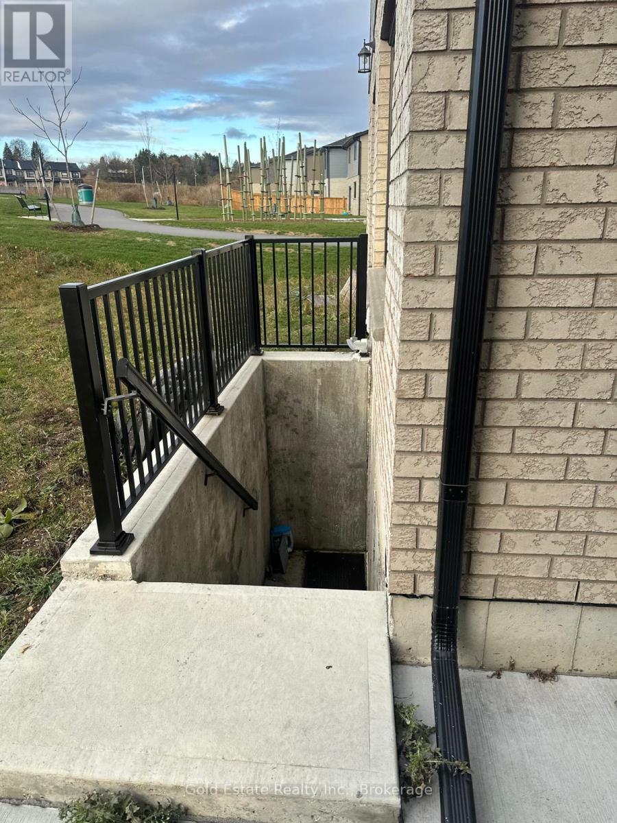 A concrete stairway with a metal railing leads to a small doorway.