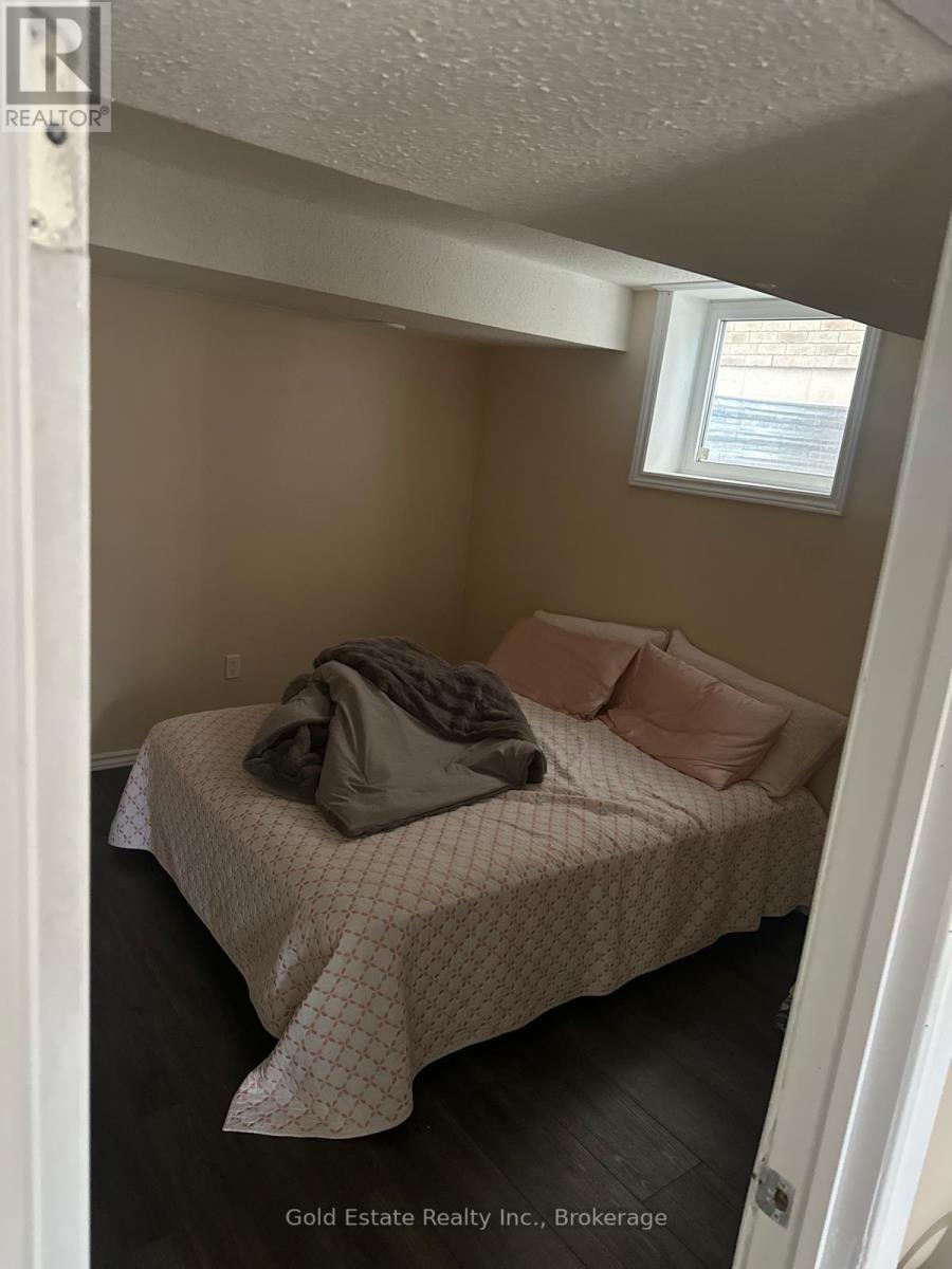 A bedroom with a bed and a window.