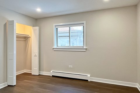 A room with a window and a white door.