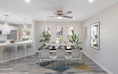 A modern dining room with a table set for six and a Christmas tree in the corner.