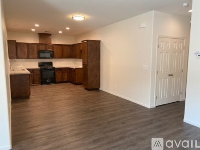 A kitchen with wooden cabinets and a black stove top oven.