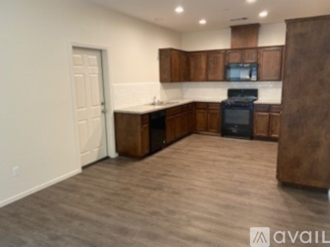 A kitchen with wooden cabinets and a black oven.