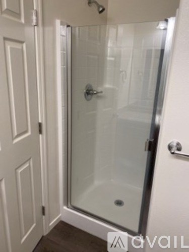 A white door with a glass shower door.