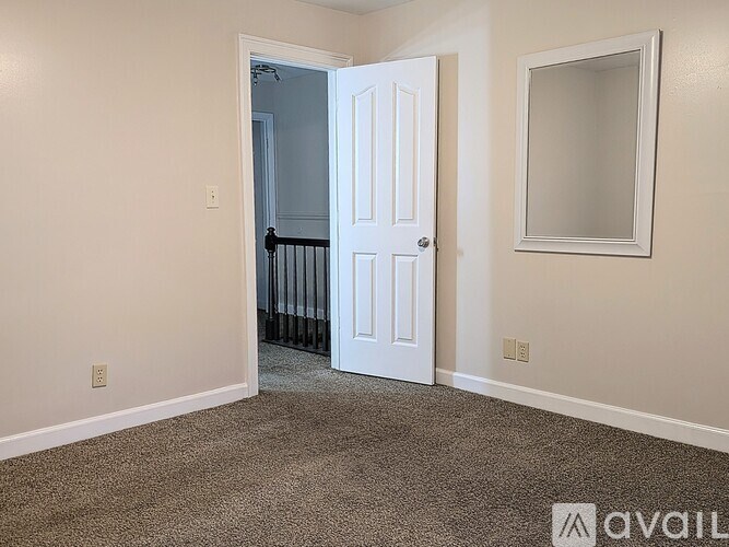 A room with a white door and a window.