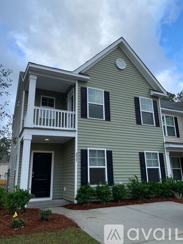 A two-story house with a balcony on the second floor.