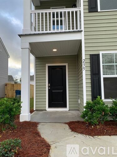 A house with a black door and a balcony.