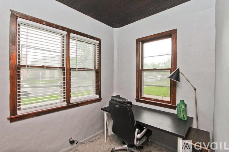 A room with a window and a chair.