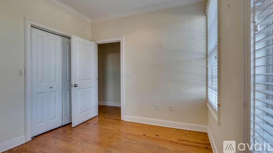 A room with two doors and wooden floors.