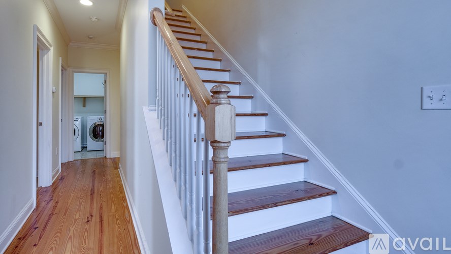 A staircase with a white railing and wooden steps.