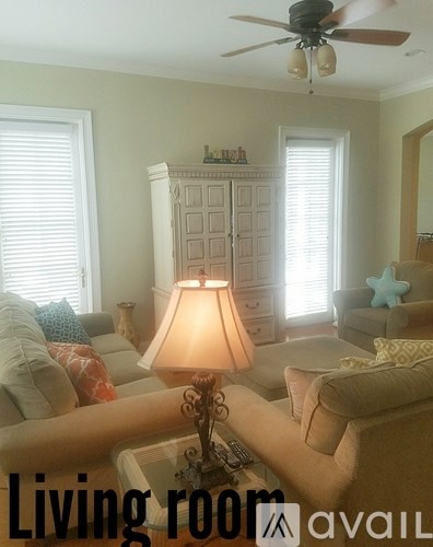 A living room with a lamp and a couch.
