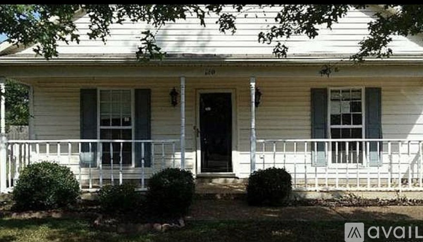 A white house with a black door and windows.