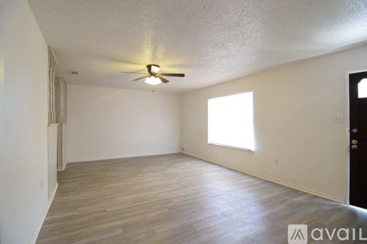 A room with a ceiling fan and a window.
