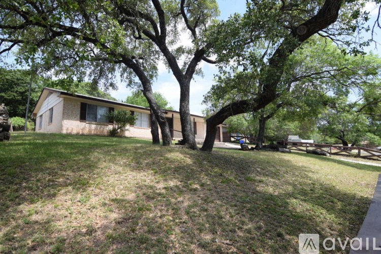 A house is surrounded by trees and grass.