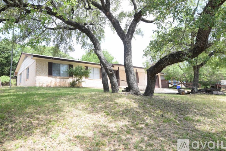 A house is surrounded by trees and grass.