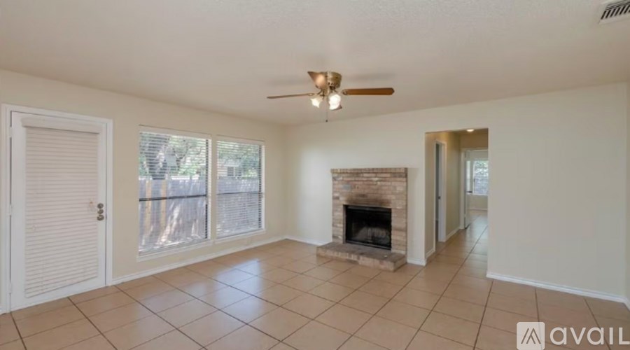 A living room with a fireplace and sliding glass doors.