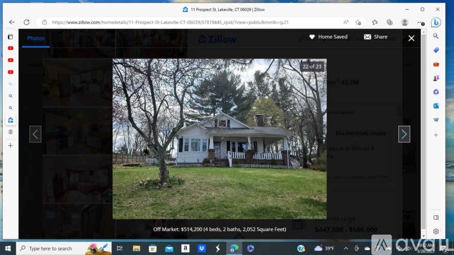 A white house with a black roof is displayed on a real estate website.