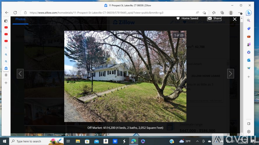 A white house with a tree in front of it.