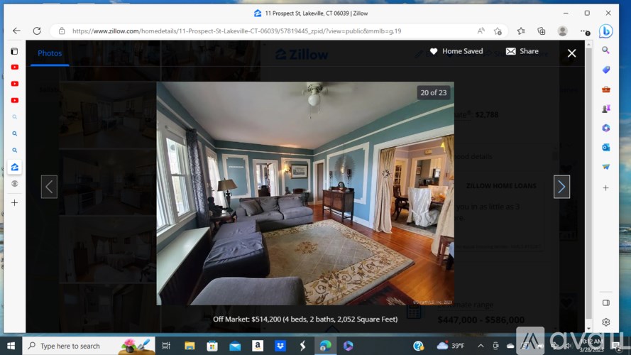 A room with blue sofas and a rug is displayed on a real estate website.