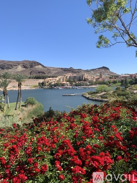 A view of a lake with a mountain in the background and a building in the middle of the lake.