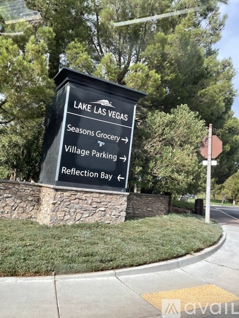 A sign for Lake Las Vegas with directions to the Seasons Grocery, Village Parking, and Reflection Bay.