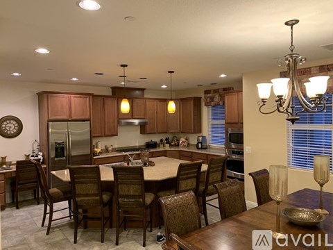 A kitchen with brown cabinets and a wooden table.