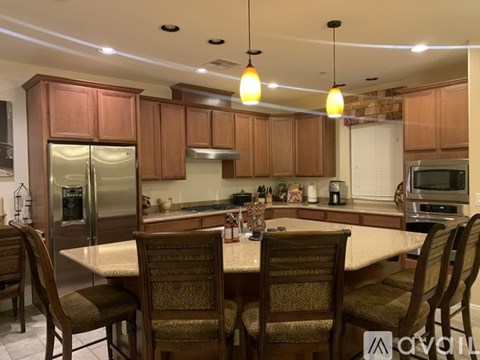 A kitchen with wooden cabinets and a table set for four.
