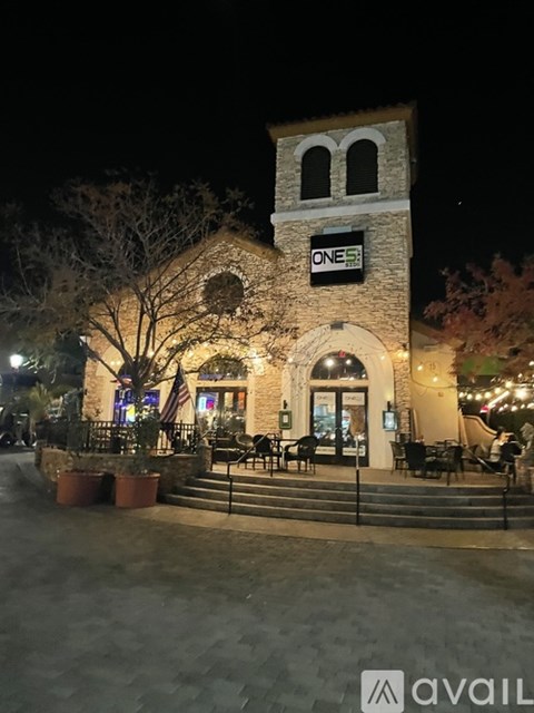 A building with a clock tower and the word "ONE" on it.