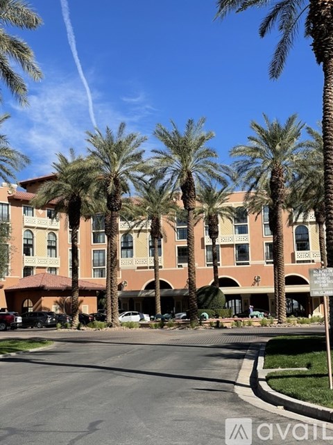A large building with palm trees in front of it.