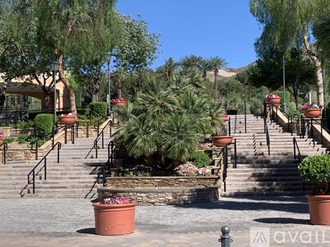 A set of outdoor stairs with a tree in the middle.