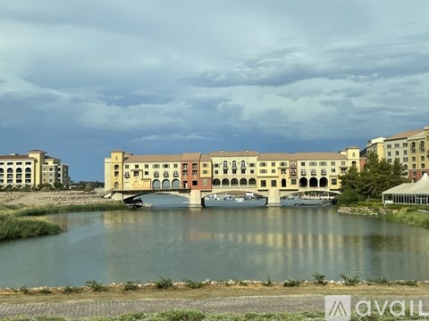 A large building with a bridge over a body of water.