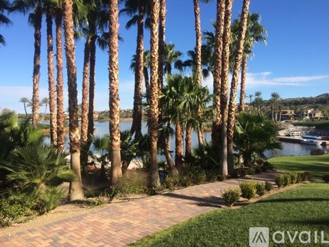 A row of palm trees in a landscaped area.