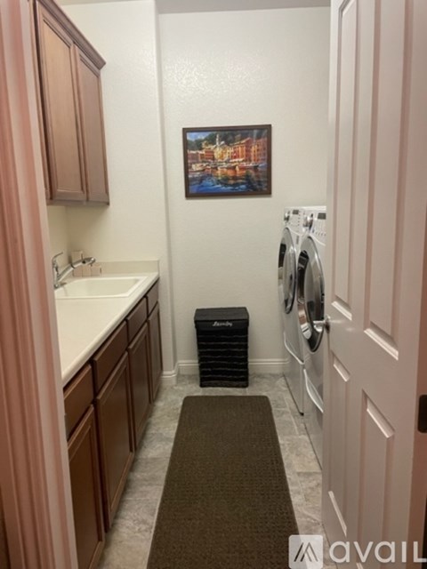 A small laundry room with a washer and dryer.