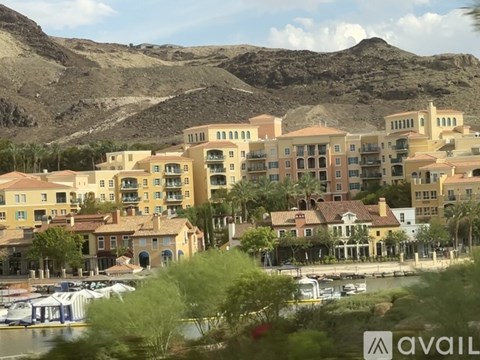 A row of buildings with a mountain in the background.