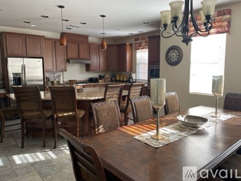 A kitchen with brown cabinets and a wooden table.