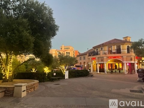 A building with a red sign that says "Mini Lounge" is lit up at dusk.