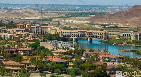 A view of a residential area with a body of water in the foreground.