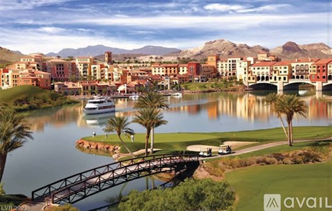 A bridge over a body of water with palm trees and buildings in the background.