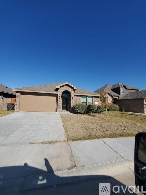 A house with a driveway and a clear blue sky.