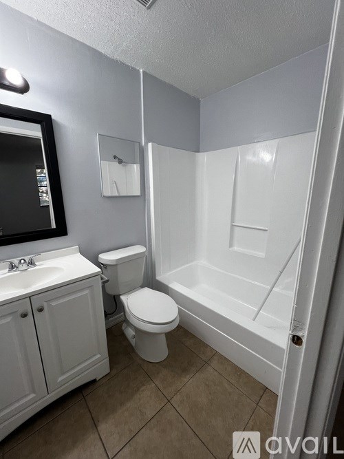 A bathroom with a toilet, sink, and bathtub.