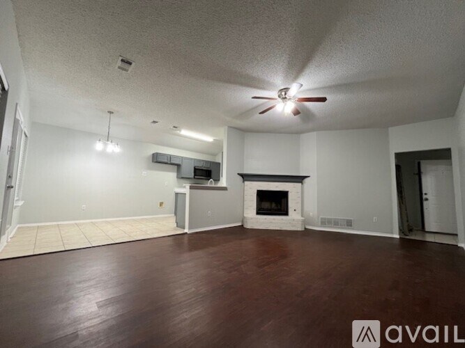 A living room with a fireplace and a television.