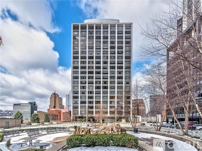 A tall building with many windows is in the center of the image.