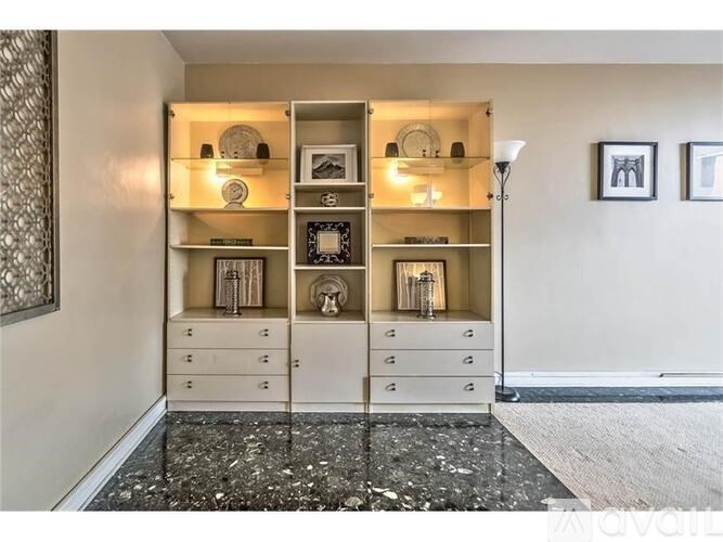A room with a large shelf and drawers.