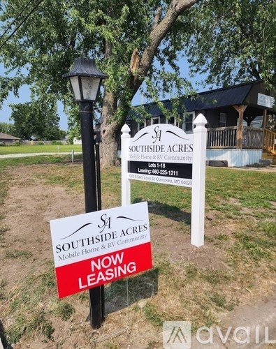 A sign for Southside Acres RV community with a red and white sign below it that says "Now Leasing".