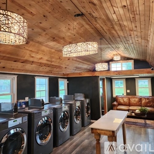 A laundry room with washers and dryers.