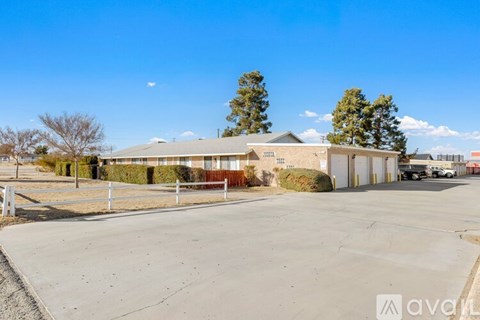 A large, empty parking lot with a building in the background.