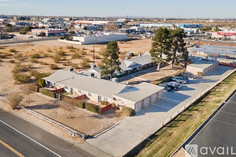 A large industrial building sits in the middle of a parking lot.