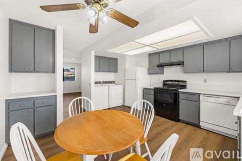 A kitchen with a table and chairs in the middle of the room.