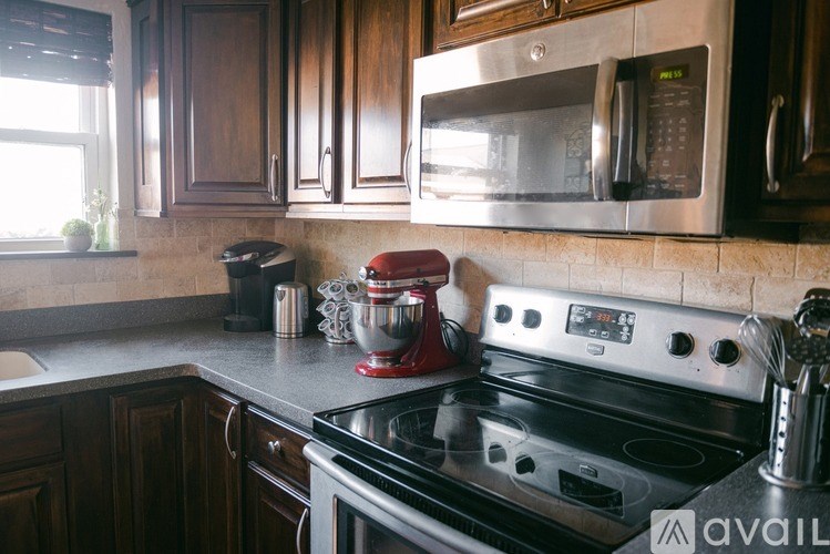 A kitchen with a stove top oven and a microwave above it.