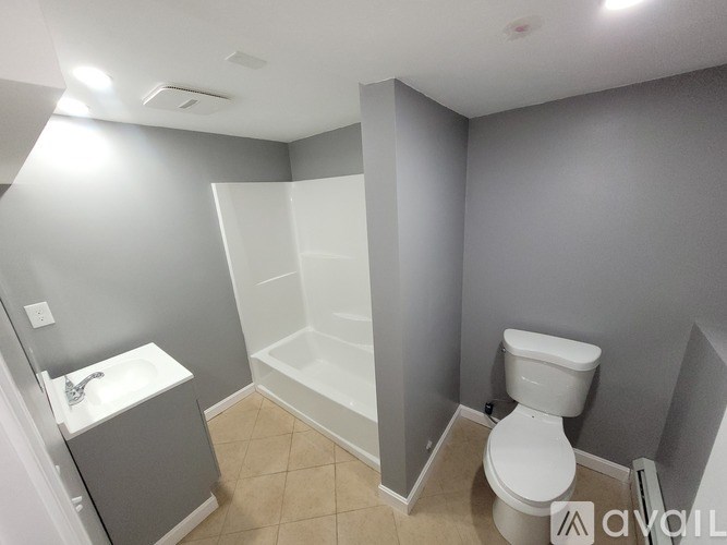A bathroom with a toilet, sink, and bathtub.