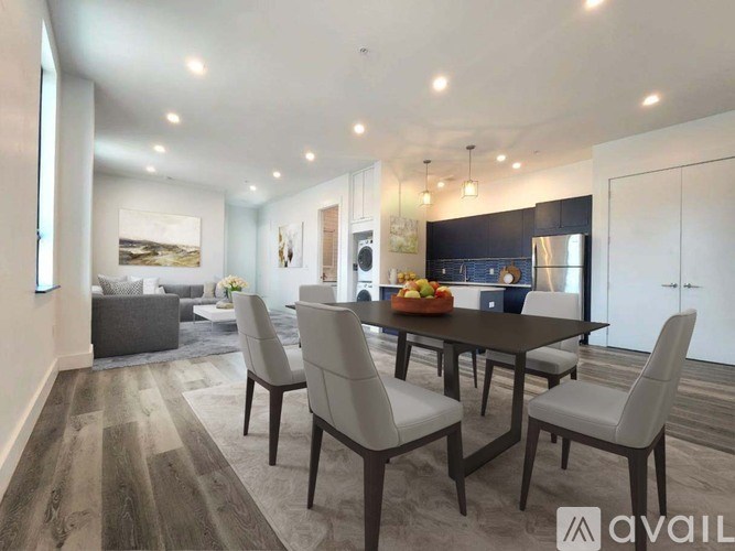 A modern dining room with a wooden table and chairs.